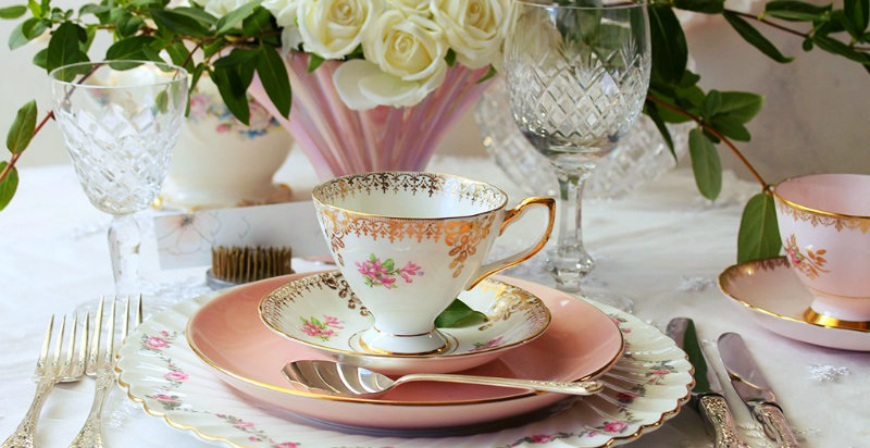 crystal glass and delicate china cup and saucer kept on the table