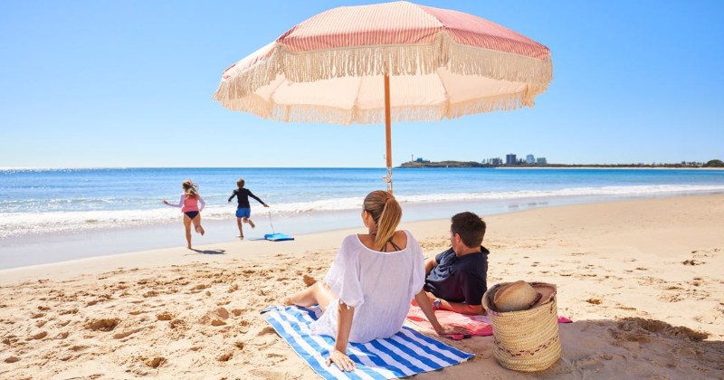 family relaxing at sunshine coast beach