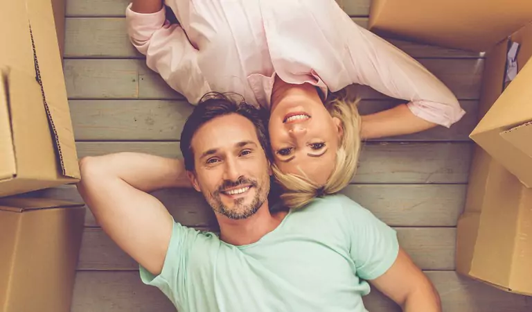 couple relaxing inside of a new house