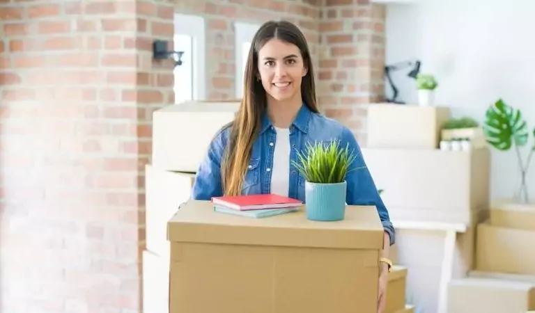 woman with a cardboard box inside of a house