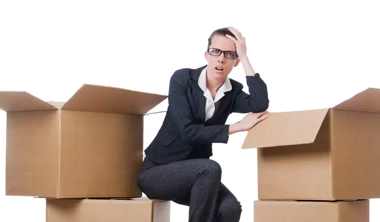 young woman looking stressed and sitting on a box