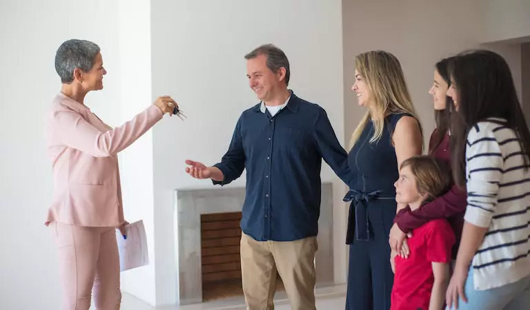 family taking the keys of their new house
