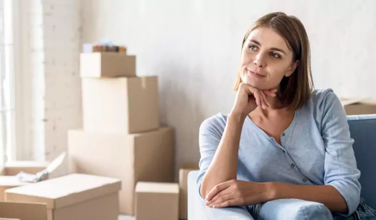 young woman sitting on a couch and thinking about something