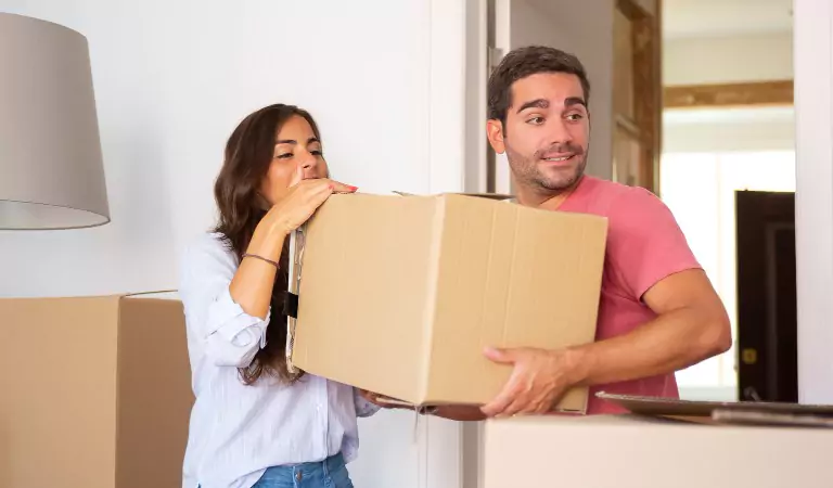 couple inside of their new house with some boxes