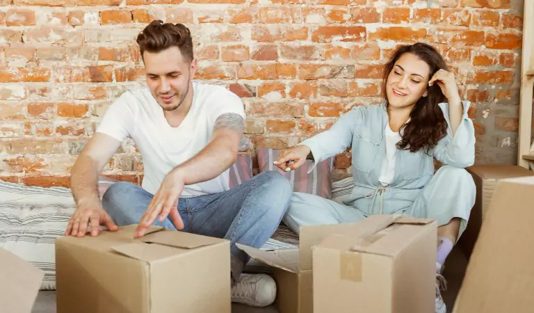 couple packing cardboard boxes