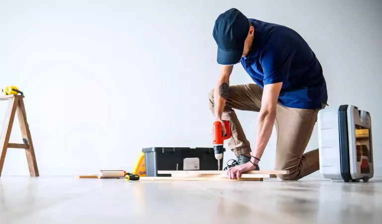 professional using a drill on a surface