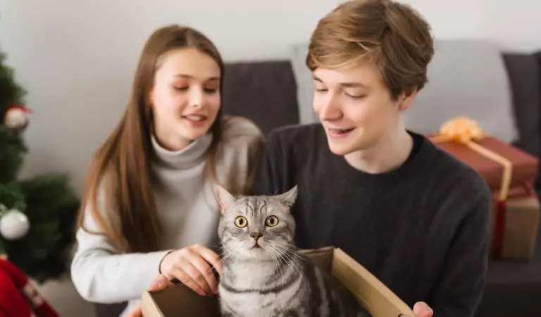 couple with their cat inside of a house