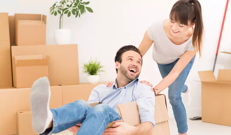 couple looking happy after moving into a new house