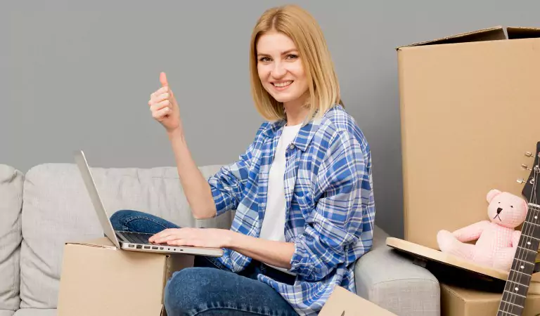 young woman sitting on the floor and working on a computer