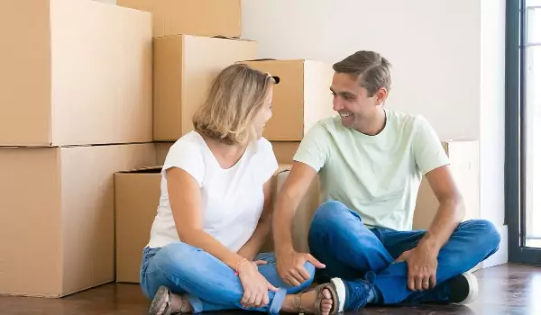 couple inside of their house sitting on the floor