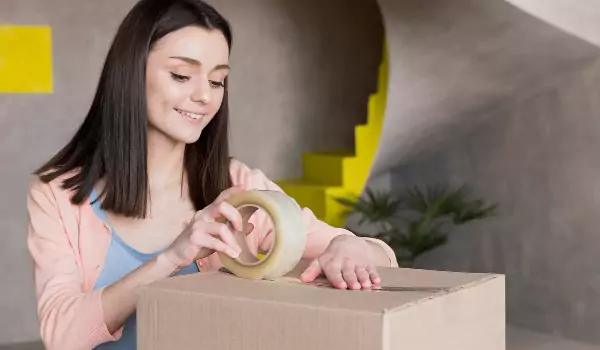 Woman packing up a cardboard box
