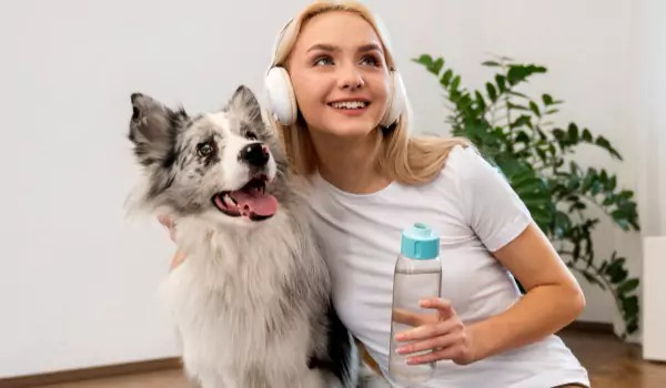 woman with her pet inside of a house