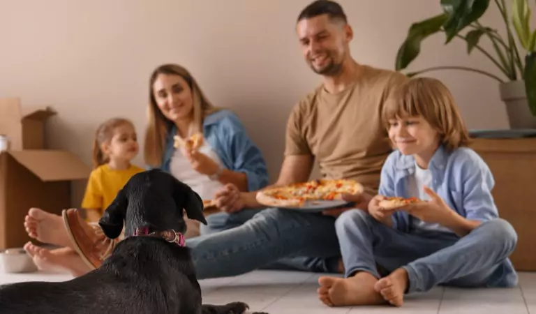 entire family enjoying pizza inside of their new house