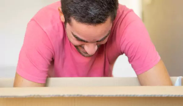 young man unpacking after a move